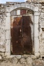 Old white rusty door in the scuffed wall Royalty Free Stock Photo