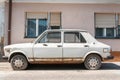 Old white rusty Fiat Zastava 101 car made in Kragujevac city, abandoned on the street.