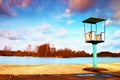 Old white and rusty metal lifeguard tower with chair on a beach. Frozen water level within witer