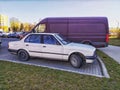 Old white sedan car BMW 316 model parked