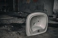 An old white sink in an abandoned building. Royalty Free Stock Photo