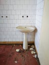 Old sink against the wall in old abandoned hospital Royalty Free Stock Photo