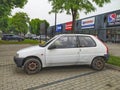 Old white small compact car Peugeot 106