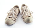dirty old beige canvas shoes isolated on white background