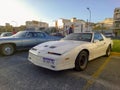 Old white sport 1989 Pontiac Firebird Trans Am Indy 500 pace car in a parking. Classic muscle car