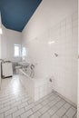 Old white tiled bathroom with bathtub - renovation concept Royalty Free Stock Photo