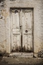 Old white timber door in the scuffed wall Royalty Free Stock Photo