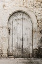 Old white timber door in the scuffed wall Royalty Free Stock Photo