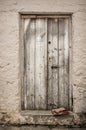 Old white timber door in the scuffed wall