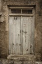 Old white timber door in the scuffed wall Royalty Free Stock Photo