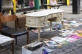 An old white vintage chest of drawers and records on the street at Brick Lane`s Sunday flea market