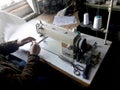 Old white vintage hand sewing machine. A man is sewing Royalty Free Stock Photo