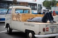 old white Volkswagen T1 pickup van with a man sleeping behind Royalty Free Stock Photo