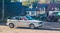 Old white VW Golf convertible driving