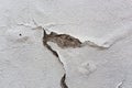 Old white wall with fallen off plaster