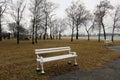 Old white bench outdoors near the lake, in the park. Royalty Free Stock Photo