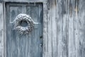 Old white wooden door with a wreath of ivy on it Royalty Free Stock Photo