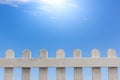 Old white wooden fence on a blue sky