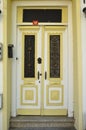 Old white and yellow wooden entrance door of house Royalty Free Stock Photo