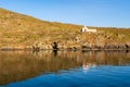 Old whitewashed abandoned Church Agios Ioannis on dramatic cliff on Kithnos Island, Greece. Royalty Free Stock Photo