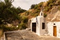 Old whitewashed small christian church built in a rock on a hill on Milos Island near Trypiti town, Greece Royalty Free Stock Photo