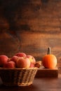 Old wicker basket with royal gala apples and pumpkin Royalty Free Stock Photo