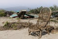 Old wicker chair on the sandy beach on the background of fishing boats in India Royalty Free Stock Photo