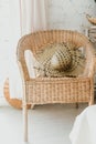 The hat rests on a wicker chair, a light interior, Summer hygge scene with hammock chair