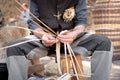 Old wicker craftsman with hands working in isolated foreground