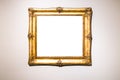 Old wide baroque gold picture frame on brown wall