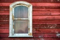 Old widow frame with dirty glass on red wooden house wall Royalty Free Stock Photo