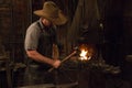 Old Wild West Blacksmith Hammering Royalty Free Stock Photo