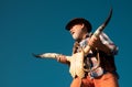 Old wild west cowboy holding cow skull. Senior western man with beard and brown jacket, hat. Buffalo bone skeleton.