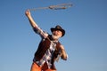 Old wild west cowboy at rodeo. Western pensioner with lasso rope. Bearded man with brown jacket and hat catching horse Royalty Free Stock Photo