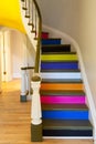 Old winding interior staircase with steps painted in different colors Royalty Free Stock Photo