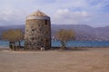 An old windmill built in stone in Elounda, Eastern Crete Greece Royalty Free Stock Photo