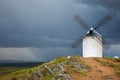 Old Windmill on dramatic sky and rain