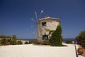 Old windmill on Greece island on the sea beach