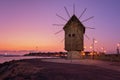 Old Windmill by an isthmus to old Nessebar Bulgaria. Ancient wooden windmill on the sea coast, Nessebar Royalty Free Stock Photo