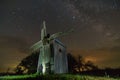 Old windmill at night with starry sky