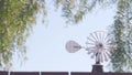 Old windmill generator on ranch or farm, vintage wind mill propeller in USA. Royalty Free Stock Photo