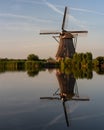 Old windmill reflected in the serene water. Kinderdijk, Netherlands Royalty Free Stock Photo