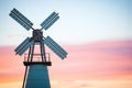 old windmill silhouette against dawn sky