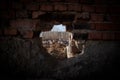 Old Windmill through Small Window in Obidos Fortress Wall, Portugal. Evening Sunlight Royalty Free Stock Photo