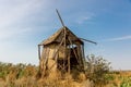 An old windmill standing in a field. Royalty Free Stock Photo