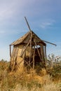 An old windmill standing in a field. Royalty Free Stock Photo