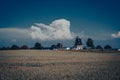 Old windmill stands behind a grain field in mecklenburg and the sky is blue Royalty Free Stock Photo