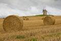 Old Windmill In A Straw Bales Field In France