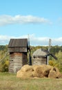 Old windmill and straw roll Royalty Free Stock Photo