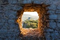 Old Windmill through Window in Fortress Wall Royalty Free Stock Photo